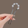 Black Chinese hairpin, cat's eye