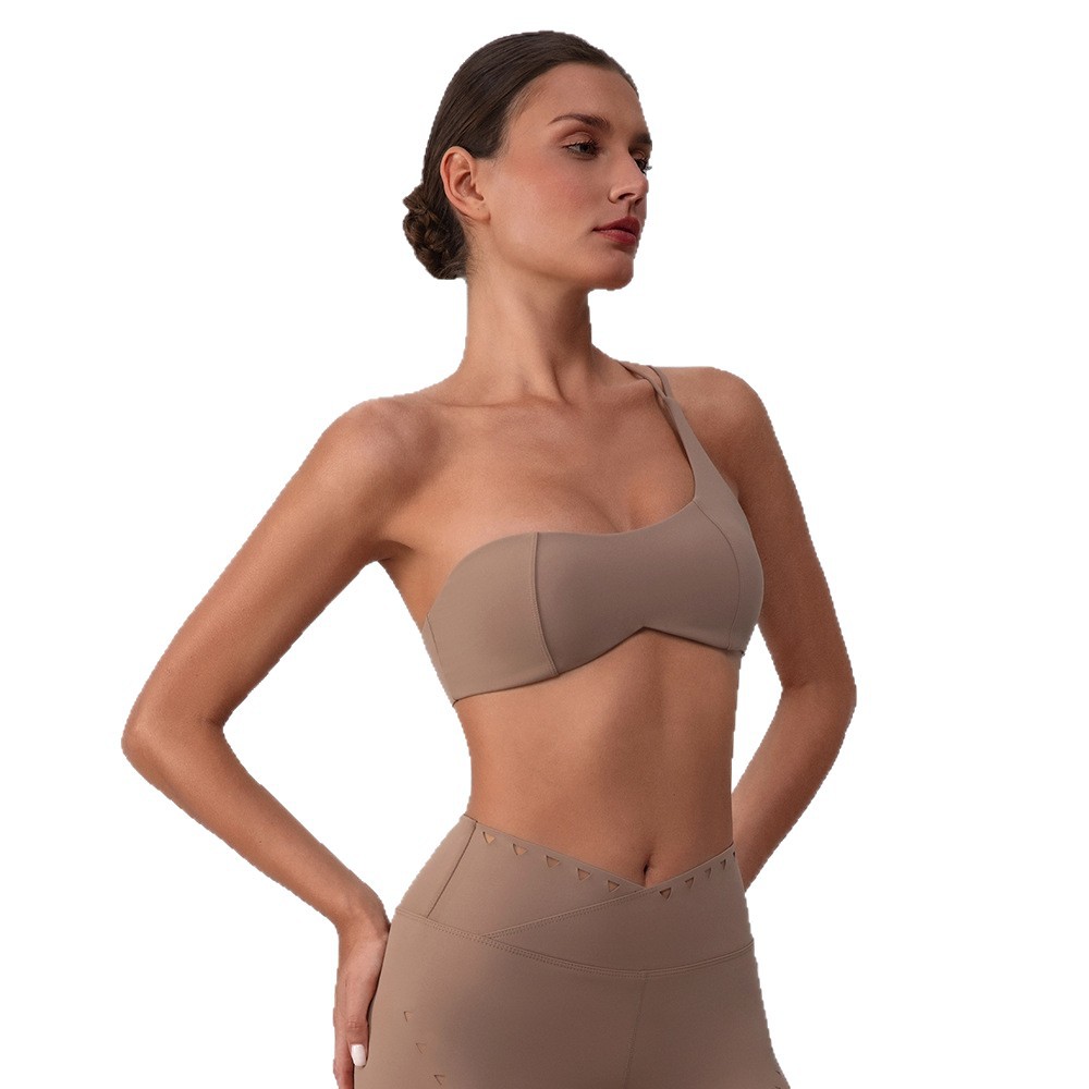 Sujetador de yoga hueco europeo y americano, almohadilla para el pecho desmontable de secado rápido, ropa interior deportiva, ropa de fitness Pilates, top de un hombro para mujer