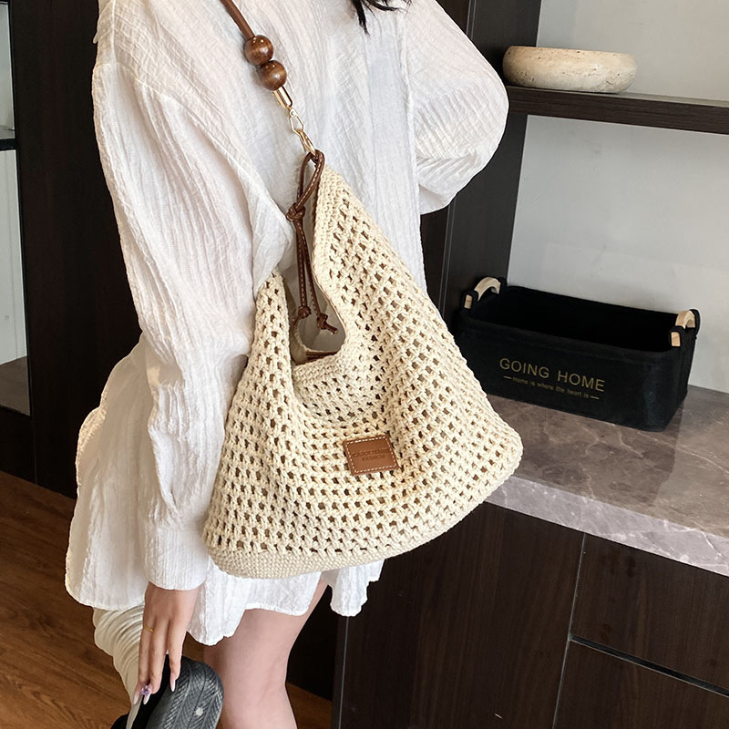Bolso tejido hueco, verano femenino, nuevo estilo, bolso tejido de paja, bolso de mensajero de un solo hombro de gran capacidad, bolso de playa de vacaciones junto al mar