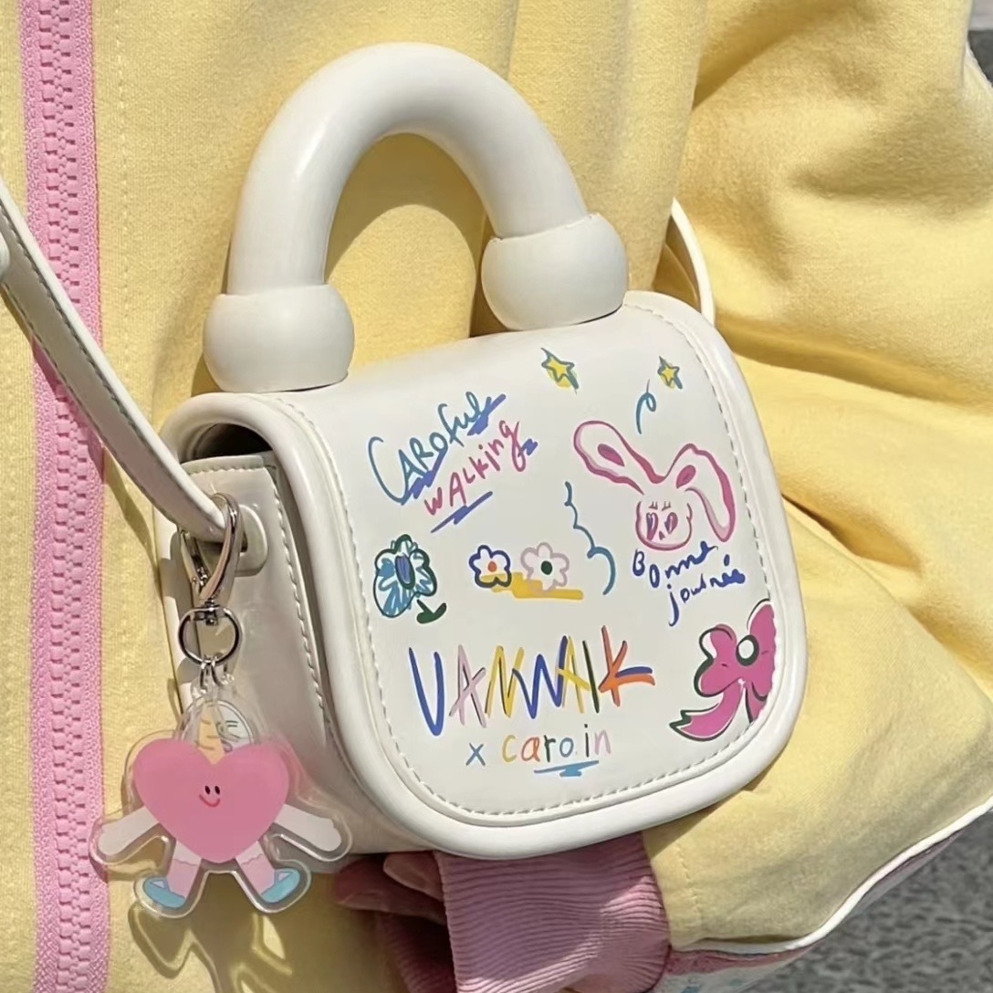 2023 primavera y verano nuevo estilo coreano estudiante bolsa de mensajero bolsa de moda Mini lindo estilo occidental de dibujos animados bolsa de graffiti para mujeres