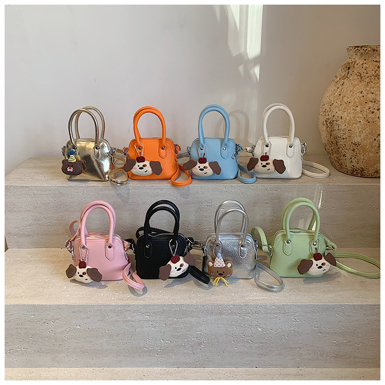 Versión coreana del bolso de hombro para niña de color sólido de dibujos animados lindo cachorro colgante bolso de bebé nuevo mini bolso para niños