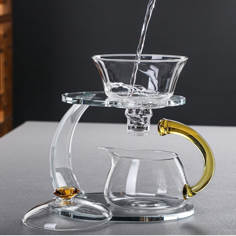 Fábrica al por mayor de vidrio resistente al calor taza de té perezoso traje hogar Kung Fu juego de té engrosada tetera de succión magnética Fabricación de té automática