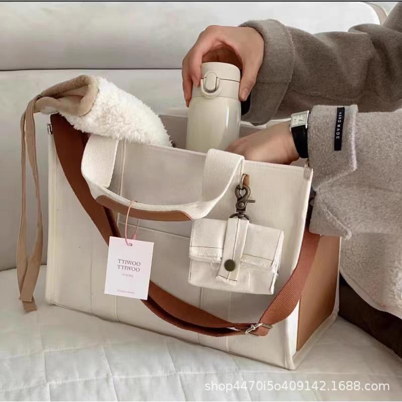 Bolsa coreana de gran capacidad simple para mamás, bolso de hombro portátil, bolso impermeable, pañales de lona, bolso para madre y bebé.