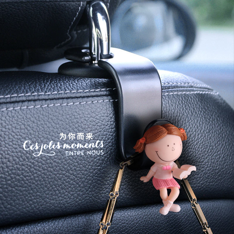 Accesorios interiores de automóviles transfronterizos gancho trasero gancho de asiento de automóvil pareja encantadora lectura de dibujos animados muñeca popularidad en línea