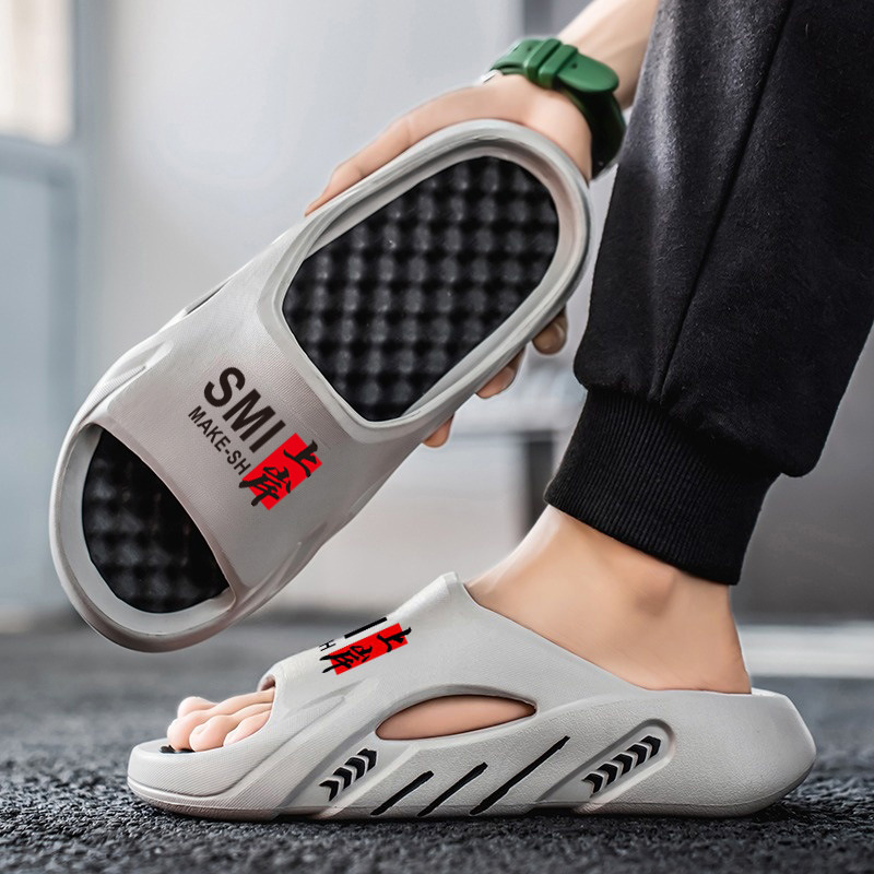 Red celebridad en vivo de verano masaje fondo de dos colores EVA zapatillas frías usar una zapatilla transfronteriza zapatillas grandes para hombres y mujeres