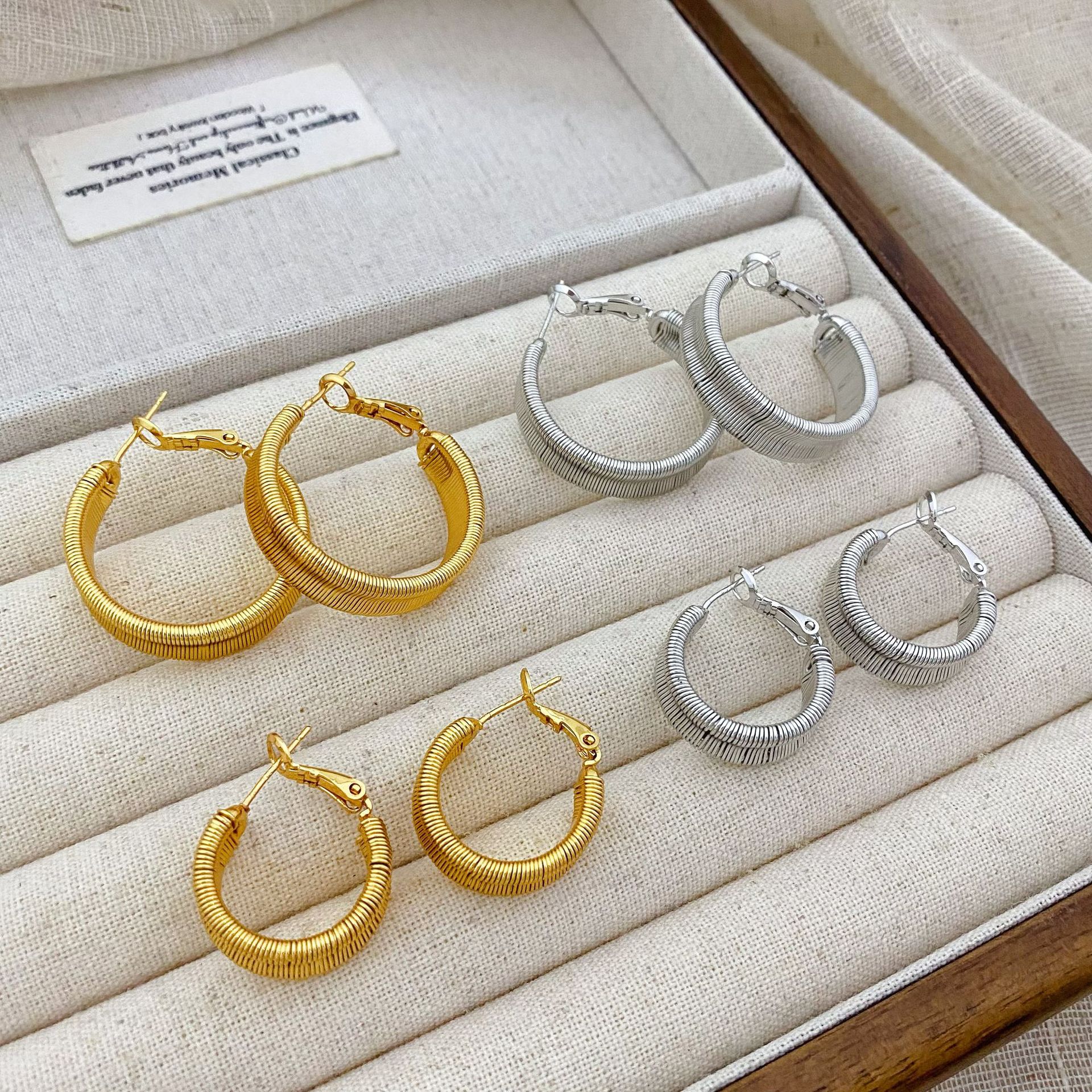 Copper plated with real gold, European and American style, wide textured twisted hoop earrings for women, new niche fashion earrings