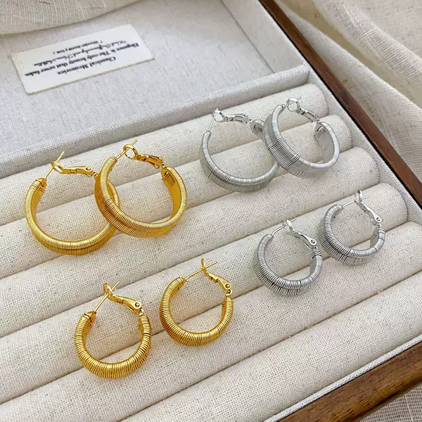 Copper plated with real gold, European and American style, wide textured twisted hoop earrings for women, new niche fashion earrings