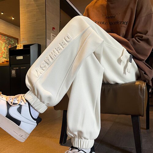 Steel-stamped letter-printed ankle-banded sweatpants for men—autumn/winter loose-fitting, wide-leg casual pants; pineapple-patterned sports pants in Japanese style.