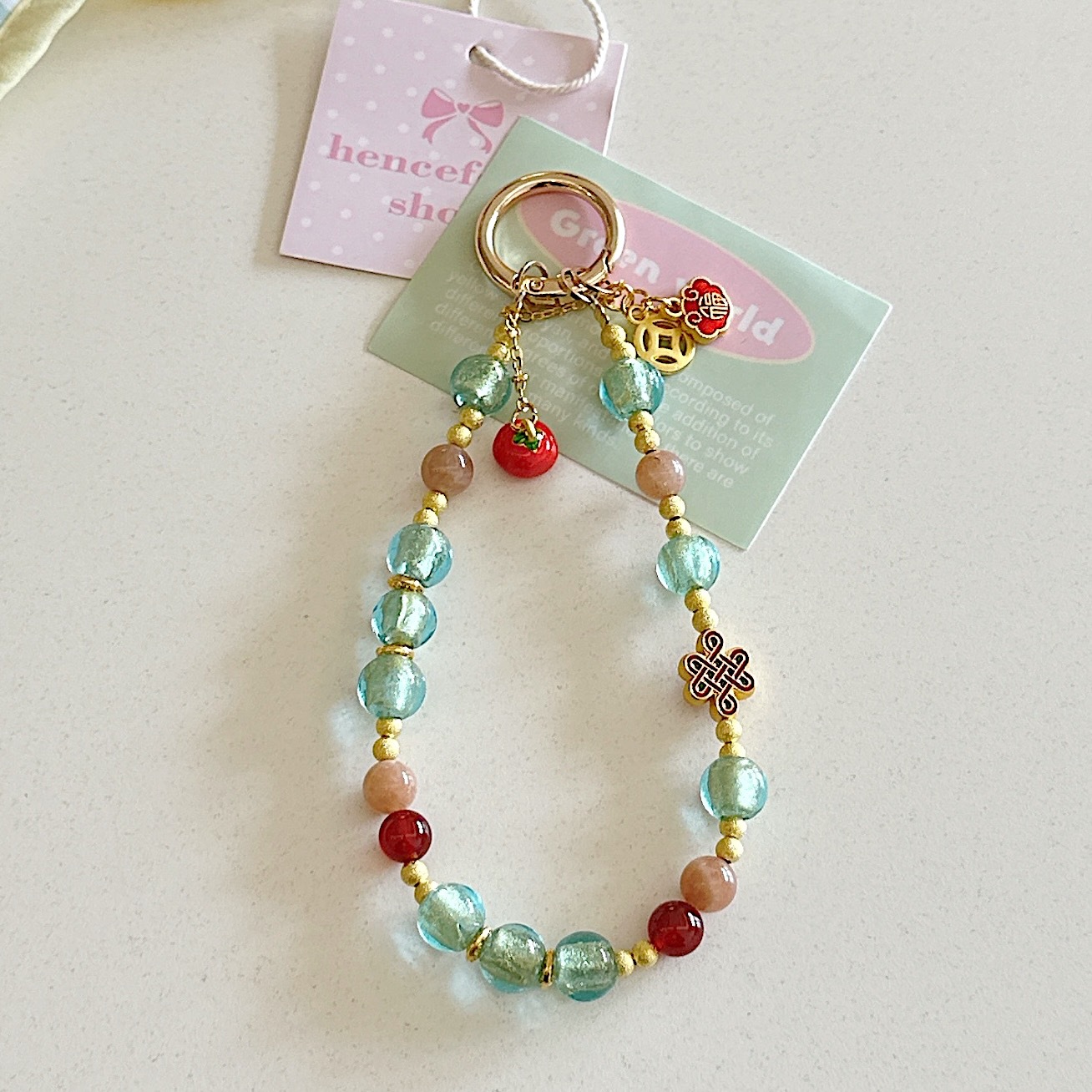 Boutique hecho a mano de alta gama cadena de teléfono móvil pulsera de caqui de vidrio de hoja de oro cordón de teléfono móvil de moda colgante de bolso corto