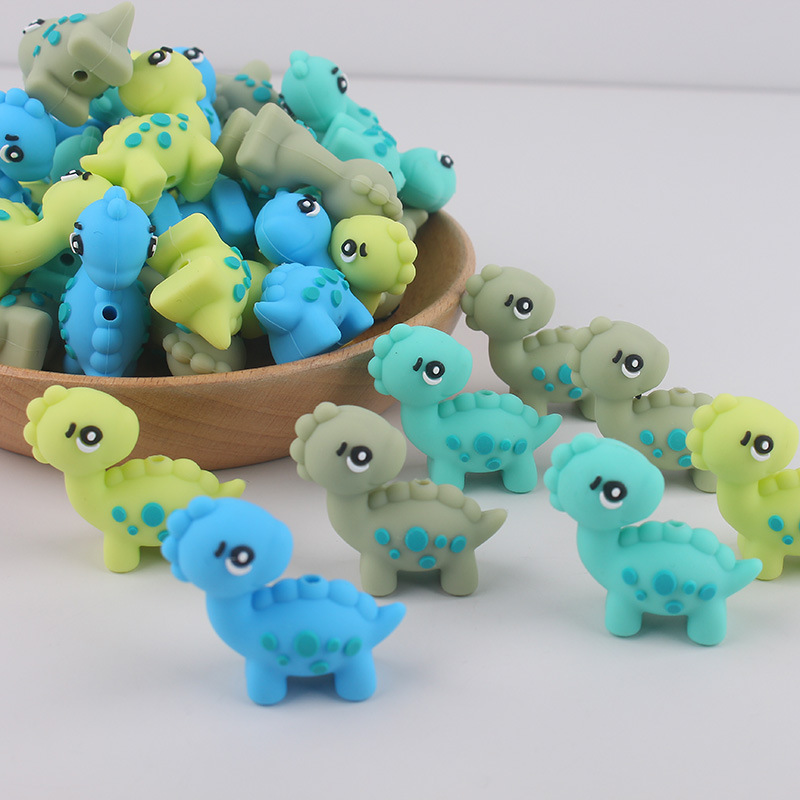 Dibujos animados Dinosaur Dental Topeador Cuentas de goteo Bolígrafo de cuentas de bricolaje Pezones para bebés Cadena anti-caída Amazon