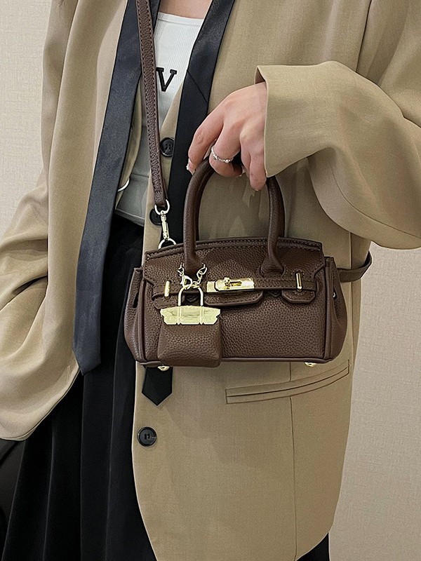 Bolso Kelly de moda coreana para mujer, nuevo modelo transfronterizo de gran venta con textura de alta calidad y diseño de lichi, bolso de hombro y bandolera.