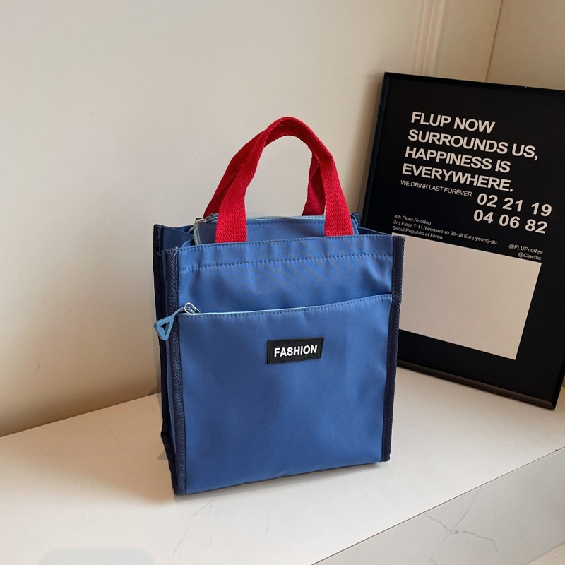 Moda coreana nueva serie de gran capacidad bolsas escolares portátiles de otoño 2024 bolsas de botellas impermeables Oxford