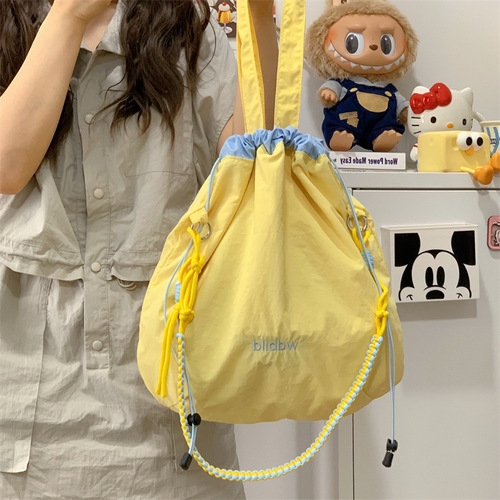 Korean style niche canvas bag, color-blocked drawstring, adjustable shoulder strap, multi-functional hand carry, contrasting color, lightweight cross-body shoulder bag