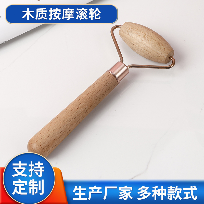 顔マッサージ顔ローラーは木製の吸着精油ローラーを持っています。|undefined