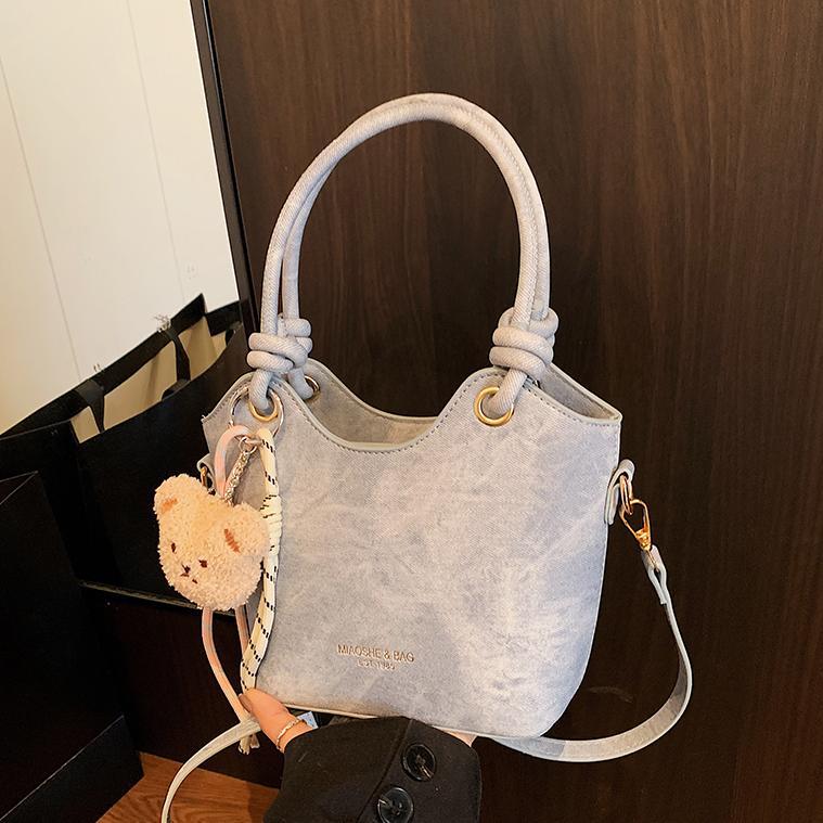 Corea del Sur ins moda bolso de cubo de mano 2025 nuevo estilo simple ocio versátil bolso de hombro textura superior