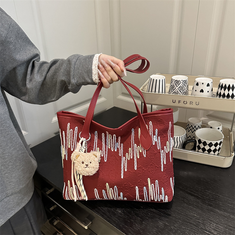 Este año, la popular bolsa de mujer de gran capacidad 2025, un nuevo colgante simplista y lindo, textura de la mochila de viaje al trabajo.