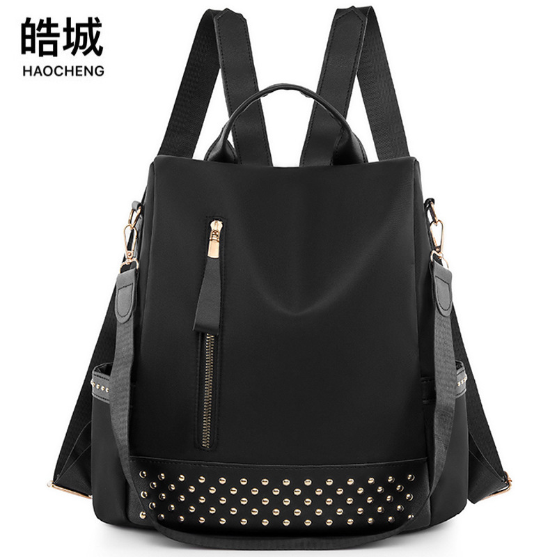 Venta al por mayor 2023 nuevo estilo casual mochila antirrobo mujer simple moda Oxford tela remache mochila escolar de doble uso