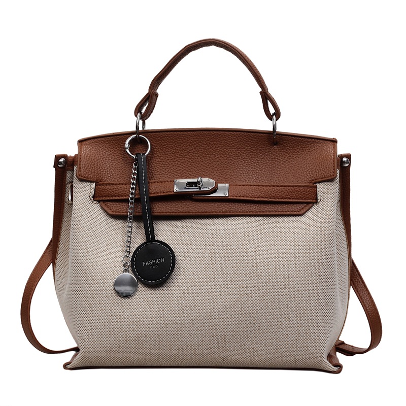 Bolso para mujeres 2026 nuevo cross-border lienzo empalme color contraste bolso de mano alta sensación retro mochila de hombro