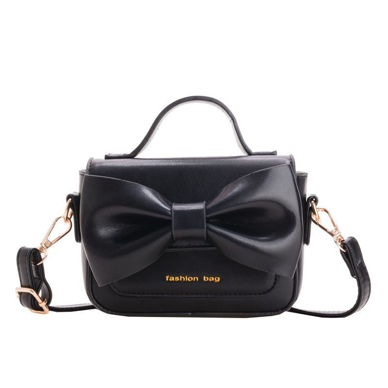 2025 nuevo bolso para niños mini accesorios para niños bolsos de mano simple color sólido arco extranjero bolso de hombro para niñas