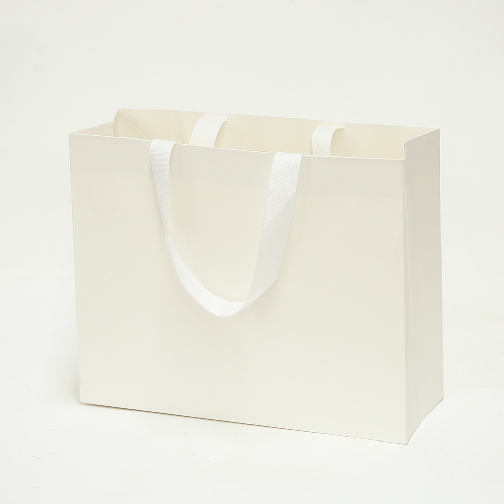 Bolsa de cartón blanco logotipo tienda de ropa bolsa de mano bolsa de regalo espesa bolsa de regalo de Navidad se puede imprimir