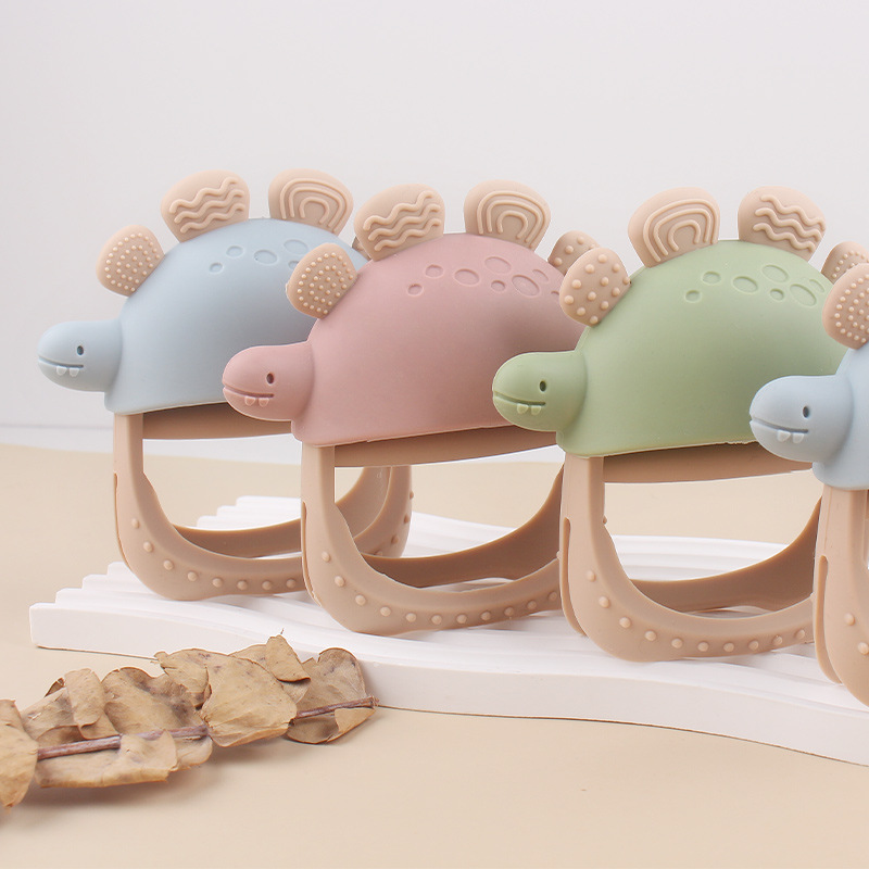 Nuevos guantes de mordedor de dinosaurio de silicona anti-comer para bebés