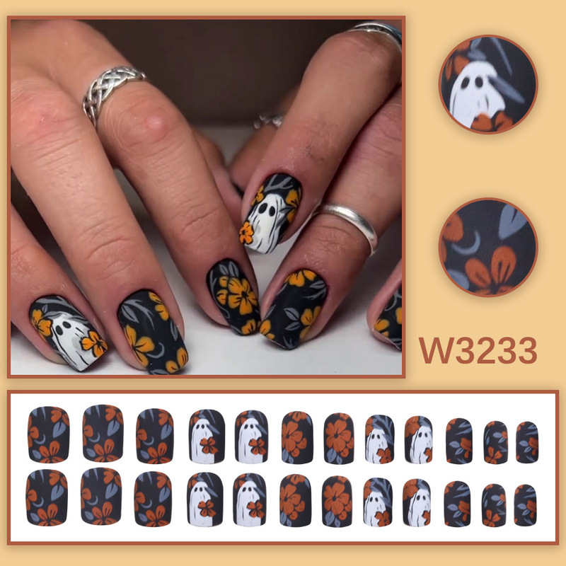 Black background with orange flowers, ghost-themed Halloween press-on nails, short square retro floral design, hand-painted holiday nail art, available for wholesale