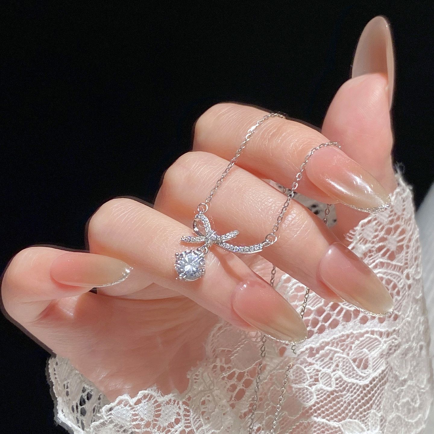 Titanium steel sparkling diamond bow necklace for girls, light luxury with a high-end feel, tassel pendant, niche versatile exquisite collarbone chain