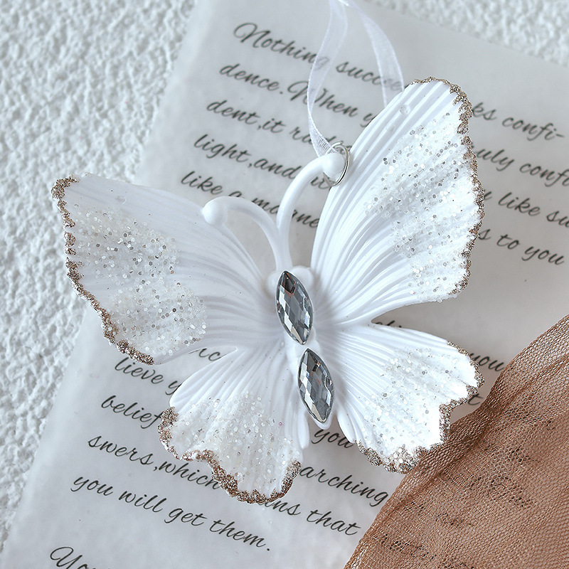 Nuevo colgante de acrílico de Navidad blanco transfronterizo, copos de nieve en polvo de brillo, paquete de regalo de árbol de Navidad de mariposa, colgante de caramelo pequeño
