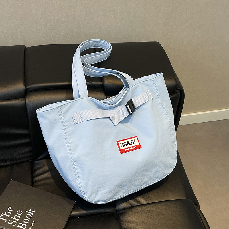 Bolso de letras coreanas 2025 verano nuevo bolso femenino bolso de lona para estudiantes bolso de hombro casual de gran capacidad