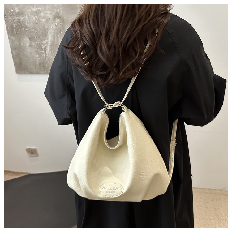 The 2024 new pleated tote bag is a large-capacity casual and fashionable backpack for women, featuring multi-functional texture and a single-shoulder crossbody bag undefined