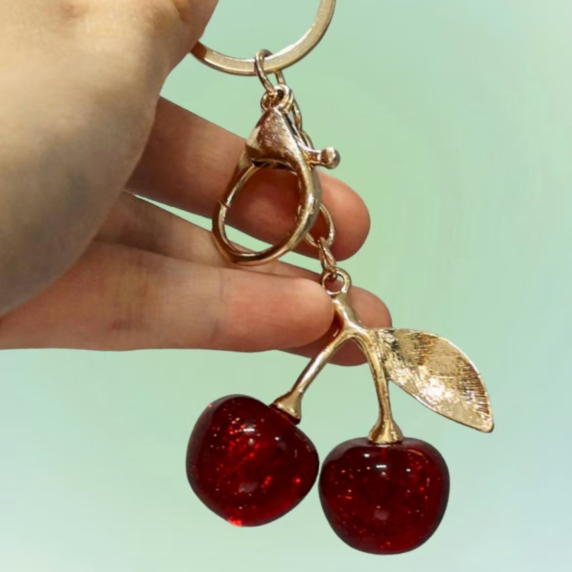 Nuevo estilo transfronterizo de moda europea y estadounidense delicado llavero de cereza de alta calidad sensación de bolsas de automóviles colgante colgante al por mayor