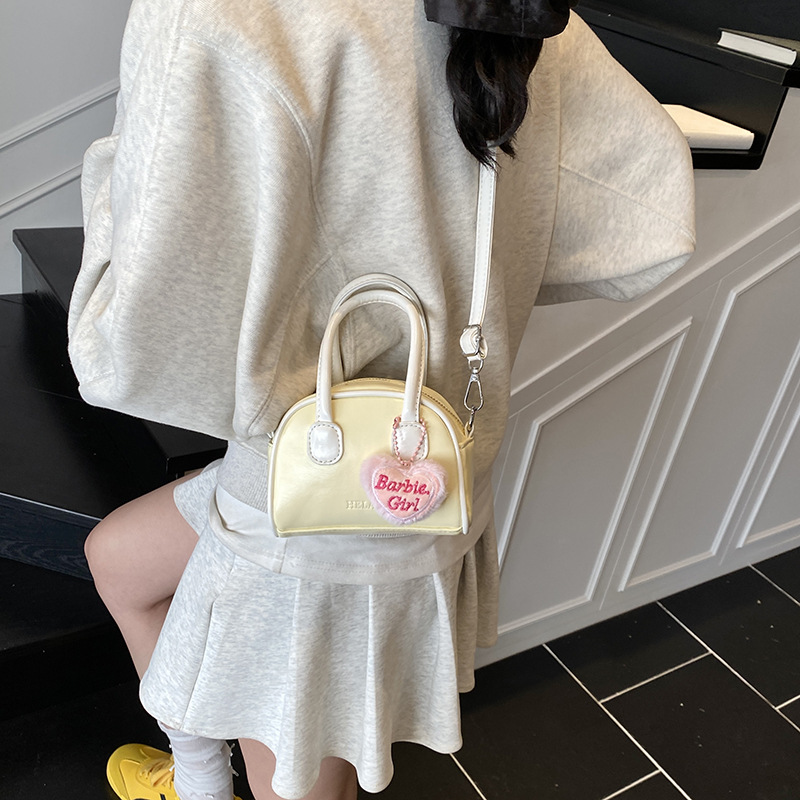 Bolsos coreanos para niños y niñas conchas de aire extranjero mini bolsos de mano de bebé de color sólido dulces bolsos para niños colgantes