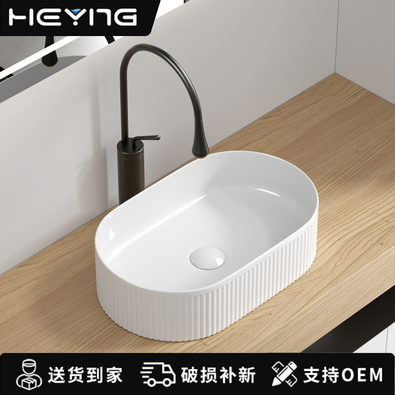 Minimalista lavabo de mesa elíptico arte cerámica lavabo de mesa hotel lavabo doméstico lavabo al por mayor
