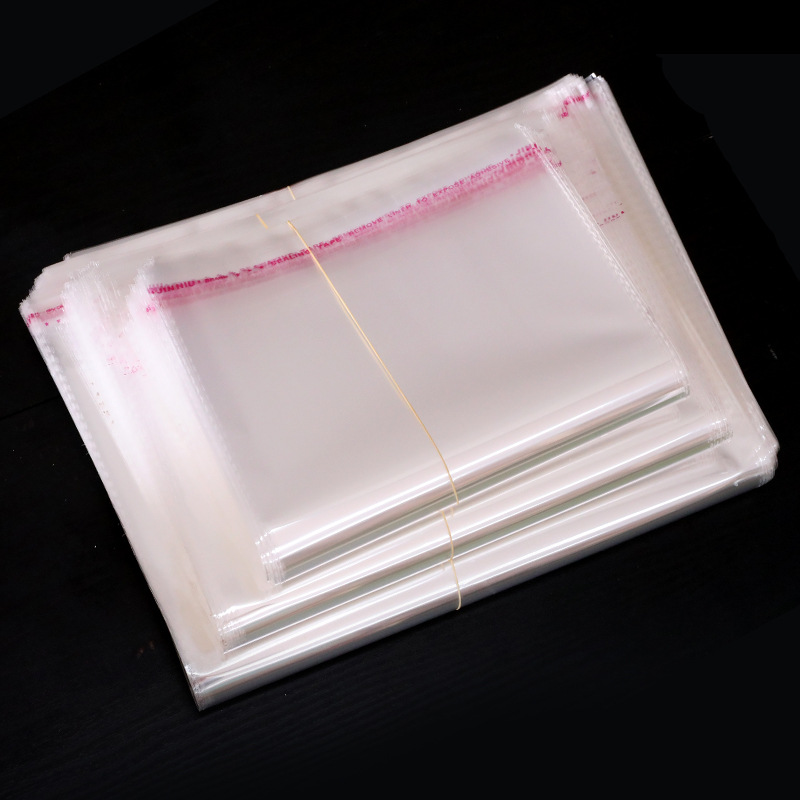 Fábrica en stock OPP bolsa autoadhesiva bolsa de embalaje de ropa transparente de fábrica al por mayor bolsa de ropa LOGO 100