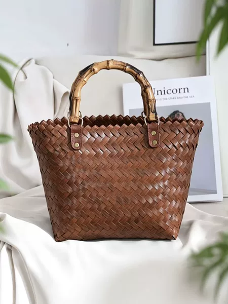 Retro-style woven tote bag with a bamboo handle, resembling a rattan basket, a large-capacity beach or vacation bag for women