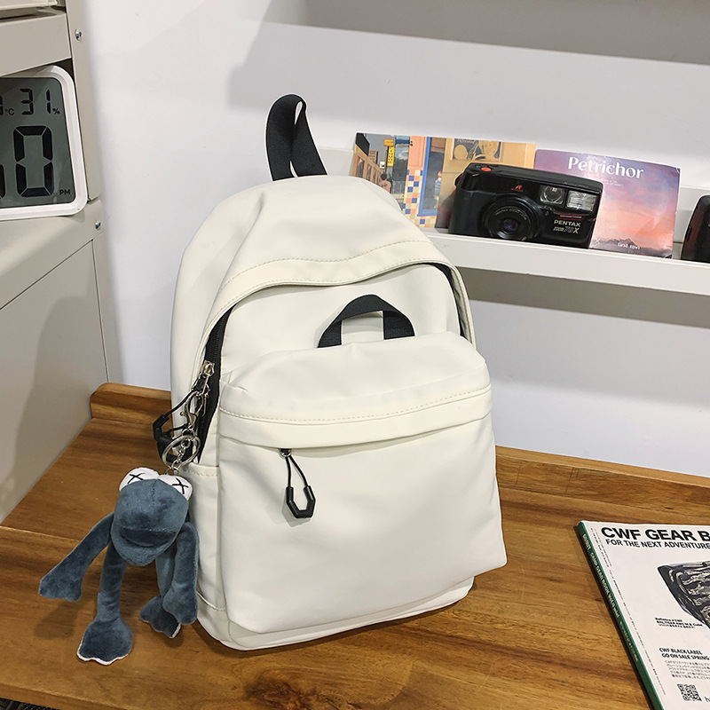 Las chicas japonesas de bolsos de lona son antiguas, impermeables, de color sólido, bolsos de nylon, Campus simple y versátil mochilas escolares para hombres de moda.