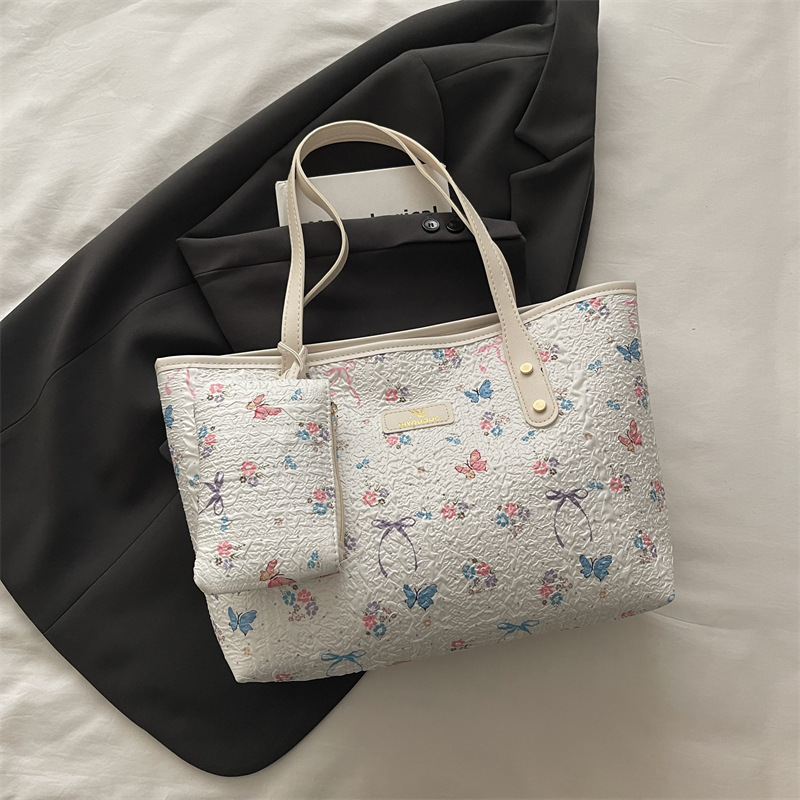 2026 flores coreanas mariposas de gran capacidad de viaje de primavera nueva moda moda extranjera bolso de hombro