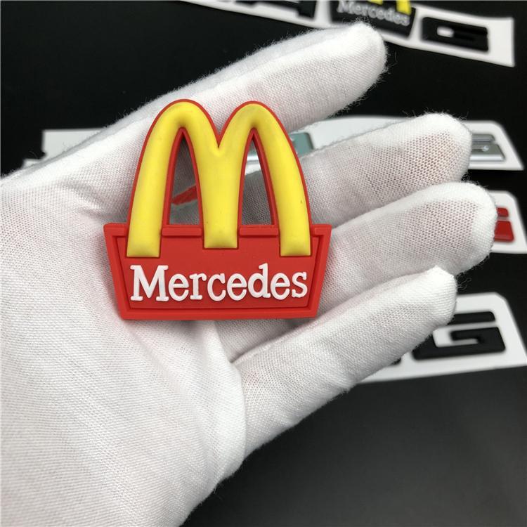 Mercedes-Benz C-Class, E-Class, and S-Class modified with AMG emblems, McDonald's car logos, BMW M logos, and new AMG tail emblems with black lettering