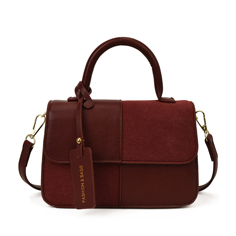Bolsos de mano de textura alta para mujeres 2025 nueva tendencia europea y americana cruzada retro empalme versátil mochila