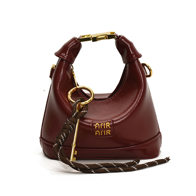 Bolso de hombro para niña coreana bolso de bebé con bloqueo de cuero de aceite de color sólido simple 2025 nuevo mini bolso para niños