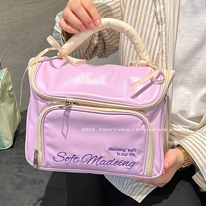 Handheld capacious cosmetic bag with bow to go out