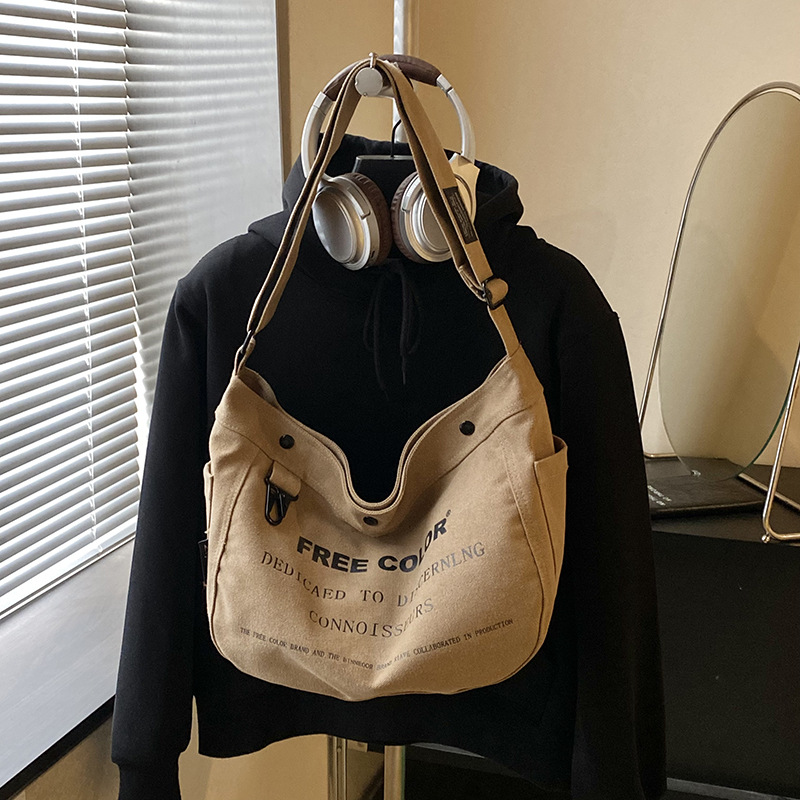 Bolsa de lona para mujeres 2026 nueva bolsa de gran capacidad transfronteriza impresa letras de viaje casual mochila de hombro
