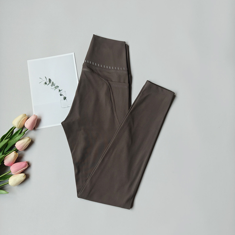 Pantalones de fitness desnudos para mujeres sonrientes líneas de elevación de cadera pantalones deportivos para mujeres al aire libre cintura alta sin marcas nueve puntos pantalones de calzado