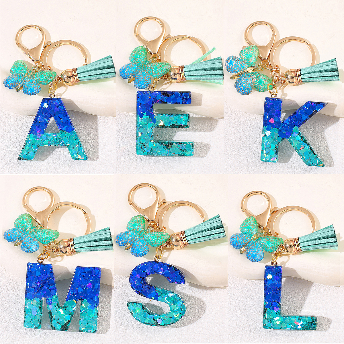 Amazon 26 letras llaveros bolsos damas colgantes colgantes sequillas letras bordas mariposa llaveros