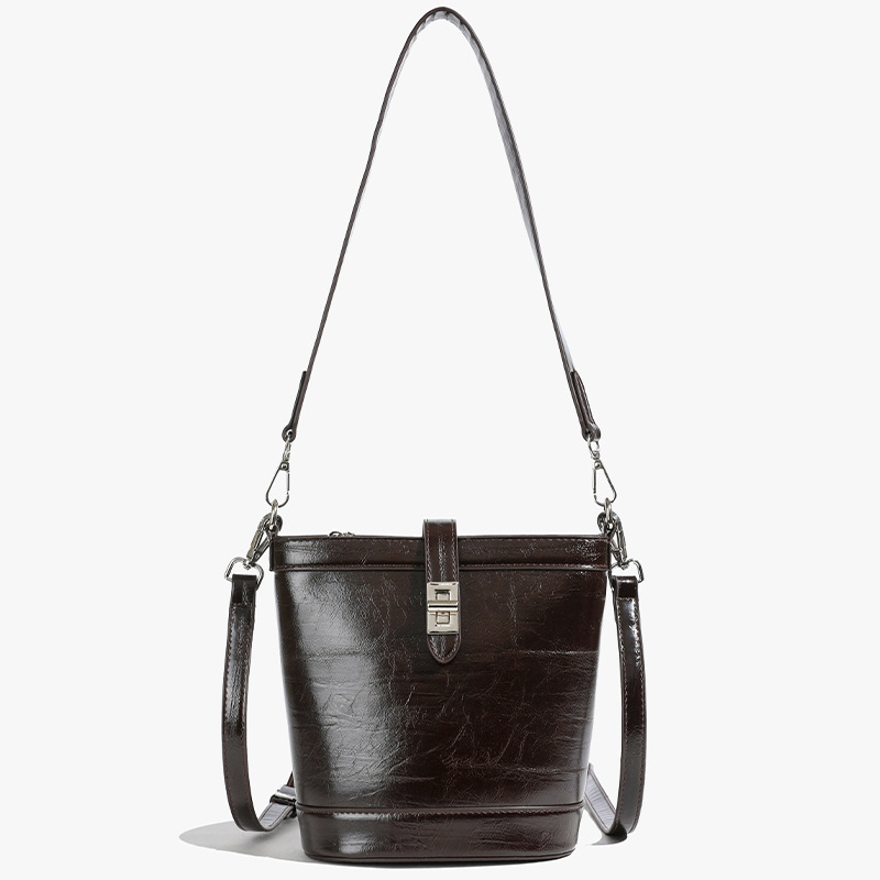 Moda simple bolso de cubo portátil mujer 2025 nuevo estilo versátil retro bolso de hombro casual alta sensación de mochila