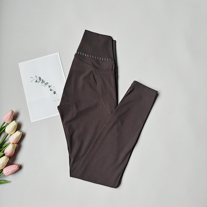 Pantalones de fitness desnudos para mujeres sonrientes líneas de elevación de cadera pantalones deportivos para mujeres al aire libre cintura alta sin marcas nueve puntos pantalones de calzado