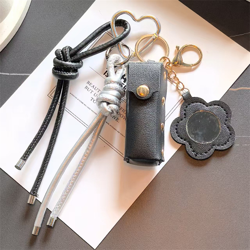Espejo de cuero transfronterizo lápiz labial bolsas de llaves creativas flores portátiles maquillaje espejo bolsas colgantes accesorios de llaves PU