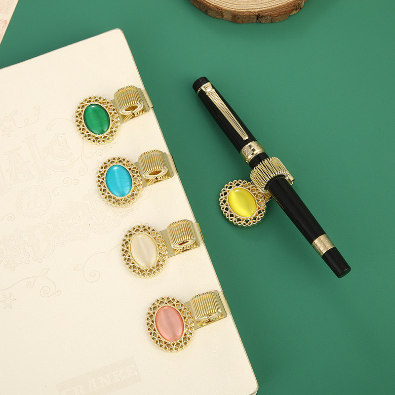 Oval cat's eye metal pen clip, zinc alloy spring pen holder, book clip, student notebook, stationery clip Oval cat's eye metal pen clip, zinc alloy spring pen holder, book clip, student notebook, stationery clip