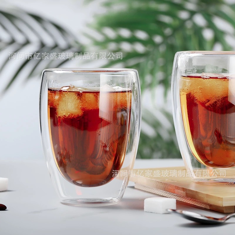 Taza de doble capa en forma de huevo al por mayor de fábrica Taza de vidrio aislante de doble capa Taza de café con leche de jugo simple Taza de vidrio para el hogar