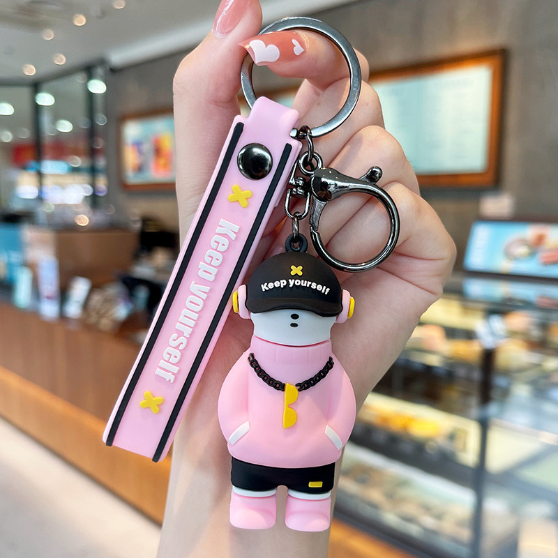 Muñeca de goma goteando bolsas escolares colgantes colgantes de muñecas colgantes de la máquina del mercado nocturno regalos al por mayor llaveros de dibujos animados